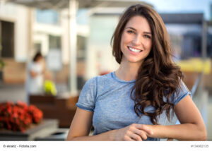 Woman similing with a beautiful brunette woman sincere happy cheerful positive expression