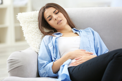 women holding stomach