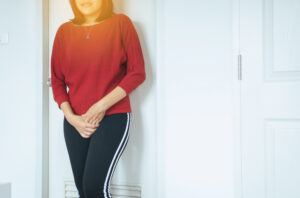 Hands woman holding her crotch