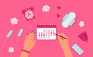clock, tampons, calendar on pink background - a menstruation concept